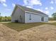 Side and rear exterior view, showcasing light blue vinyl siding and green landscaping at 813 Highway 67, Loris, SC 29569