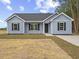 Charming one-story home with blue siding, black shutters, and a manicured lawn at 813 Highway 67, Loris, SC 29569