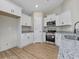 Bright kitchen features white cabinets, granite countertops, and stainless steel appliances at 813 Highway 67, Loris, SC 29569