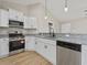 This open kitchen features stainless steel appliances and granite countertops at 813 Highway 67, Loris, SC 29569