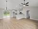 Bright, open-concept space featuring wood floors, white cabinetry, and a kitchen island at 813 Highway 67, Loris, SC 29569