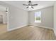 A spacious bedroom with a ceiling fan and a large window letting in natural light at 825 Highway 67, Loris, SC 29569