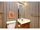 This simple bathroom offers a neutral vanity, large mirror, and neutral paint at 9501 Shore Dr. # D-337, Myrtle Beach, SC 29572