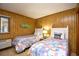 Cozy bedroom featuring twin beds, wood-paneled walls, and beachy decor at 9501 Shore Dr. # D-337, Myrtle Beach, SC 29572