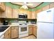 Bright kitchen features light wood cabinets, white appliances, and a view to the living area at 9501 Shore Dr. # D-337, Myrtle Beach, SC 29572
