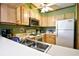 Charming kitchen features light wood cabinets, white appliances, and ample counter space at 9501 Shore Dr. # D-337, Myrtle Beach, SC 29572