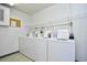 Convenient laundry room featuring multiple white washing machines and overhead shelving at 9501 Shore Dr. # D-337, Myrtle Beach, SC 29572