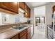 Functional kitchen with a double sink and a view into the living and dining area at 9661 Shore Dr. # B-22, Myrtle Beach, SC 29572
