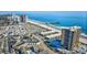 A high-angle aerial view of a beachfront community near a pier and popular resort area at 9671 Stillwater Ct., Myrtle Beach, SC 29572