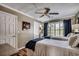 Bright bedroom features two twin beds, a ceiling fan, and plantation shutters overlooking the outdoors at 9671 Stillwater Ct., Myrtle Beach, SC 29572