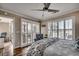 Bedroom with ceiling fan, plantation shutters, and sliding glass door to an outdoor patio at 9671 Stillwater Ct., Myrtle Beach, SC 29572