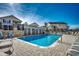 Community pool surrounded by lounge chairs, palm trees, and a well-maintained patio area at 9671 Stillwater Ct., Myrtle Beach, SC 29572