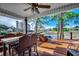 Covered outdoor deck with golf course view, ceiling fan, and wicker furniture for relaxing and enjoying the scenery at 9671 Stillwater Ct., Myrtle Beach, SC 29572