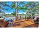 Inviting wood deck with wicker furniture, offering a serene view of the golf course and surrounding water at 9671 Stillwater Ct., Myrtle Beach, SC 29572