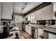 Modern kitchen with stainless steel appliances, white cabinetry, hardwood floors, and ample counter space at 9671 Stillwater Ct., Myrtle Beach, SC 29572
