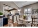 Well-lit kitchen with stainless steel appliances, white cabinets, and an adjacent dining area at 9671 Stillwater Ct., Myrtle Beach, SC 29572