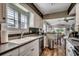 Modern kitchen with stainless steel appliances, white cabinets and an open view of the dining and living areas at 9671 Stillwater Ct., Myrtle Beach, SC 29572
