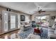 Bright living room featuring vaulted ceilings, hardwood floors and large windows with a scenic view at 9671 Stillwater Ct., Myrtle Beach, SC 29572