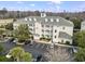 Aerial view of a three-story building with dormer windows and a parking lot with palm trees at 1033 World Tour Blvd. # 101-A, Myrtle Beach, SC 29579