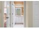 Hallway view into a bathroom with granite counters, white cabinets, and decorative lighting at 1033 World Tour Blvd. # 101-A, Myrtle Beach, SC 29579