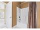 Bathroom featuring a white shower-tub combo with a decorative shower curtain and a white door leading outside at 1033 World Tour Blvd. # 101-A, Myrtle Beach, SC 29579