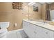 Bathroom featuring a double sink vanity with granite countertops and decorative artwork above the toilet at 1033 World Tour Blvd. # 101-A, Myrtle Beach, SC 29579