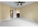 Bedroom with carpeted floors, a ceiling fan, and doorway access to an ensuite bathroom and adjacent kitchen at 1033 World Tour Blvd. # 101-A, Myrtle Beach, SC 29579