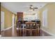 View of dining area with hardwood floors and a kitchen with white cabinets and stainless steel appliances in the background at 1033 World Tour Blvd. # 101-A, Myrtle Beach, SC 29579