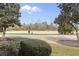 View of a golf course with two golfers and mature trees at 1033 World Tour Blvd. # 101-A, Myrtle Beach, SC 29579