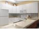 Bright kitchen featuring white cabinetry and stone countertops at 1033 World Tour Blvd. # 101-A, Myrtle Beach, SC 29579