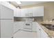 Bright kitchen with white cabinets, granite counters and stainless steel appliances at 1033 World Tour Blvd. # 101-A, Myrtle Beach, SC 29579