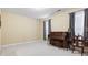 Living room with a piano, carpeted floor, neutral walls, and two windows with curtains at 1033 World Tour Blvd. # 101-A, Myrtle Beach, SC 29579