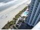Aerial view showcasing ocean, high-rise condos, and pool area at 107 Ocean Blvd. S # 1707, Myrtle Beach, SC 29577