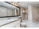 Bright bathroom features a granite countertop, tile shower, and a large mirror at 107 Ocean Blvd. S # 1707, Myrtle Beach, SC 29577