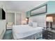 Cozy bedroom features a plush queen bed and a mounted television at 107 Ocean Blvd. S # 1707, Myrtle Beach, SC 29577