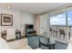 Living space with balcony ocean view, dining table and entertainment center at 107 Ocean Blvd. S # 1707, Myrtle Beach, SC 29577