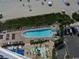 Aerial view of pool with ample seating and lounge chairs and beach access at 107 Ocean Blvd. S # 1707, Myrtle Beach, SC 29577