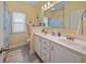 Cheerful bathroom featuring double sinks, white cabinets, and a shower with decorative accents at 109 Astoria Park Loop, Conway, SC 29526