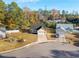 Aerial view of a cozy neighborhood showcasing well-maintained lawns and tree-lined streets under a blue sky at 1108 Patricia Ct., Conway, SC 29526