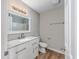 Bathroom features a large mirror, vanity, white cabinets and wood-look floors at 1108 Patricia Ct., Conway, SC 29526