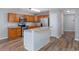Kitchen with wooden cabinets, stainless steel appliances, breakfast bar and wood-look floors at 1108 Patricia Ct., Conway, SC 29526