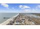 Aerial view of oceanfront homes with a fishing pier and marsh views located in a coastal community at 132 Garden City Retreat Dr., Murrells Inlet, SC 29576