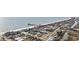 Aerial view of a quaint coastal town, featuring beachside properties, a pier, and the serene ocean at 132 Garden City Retreat Dr., Murrells Inlet, SC 29576
