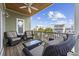 Deck showcasing comfortable wicker seating and a view of neighborhood homes with palm trees against a blue sky at 132 Garden City Retreat Dr., Murrells Inlet, SC 29576