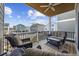 Outdoor deck furnished with comfortable seating and an inviting view of neighborhood homes and blue skies at 132 Garden City Retreat Dr., Murrells Inlet, SC 29576