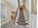 Inviting entryway with tiled floor, coat hooks, and carpeted stairs leading to the main living area at 132 Garden City Retreat Dr., Murrells Inlet, SC 29576