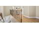 Hallway featuring hardwood floors, iron railings, and a door with glass, brightened by natural light at 132 Garden City Retreat Dr., Murrells Inlet, SC 29576