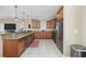 Modern kitchen with stainless steel appliances, granite countertops, and tiled flooring at 132 Garden City Retreat Dr., Murrells Inlet, SC 29576