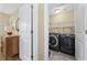 Convenient laundry room is equipped with front load machines and wire shelving at 132 Garden City Retreat Dr., Murrells Inlet, SC 29576