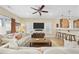 Comfortable living room with ceiling fan, large TV, and breakfast bar overlooking the kitchen at 132 Garden City Retreat Dr., Murrells Inlet, SC 29576